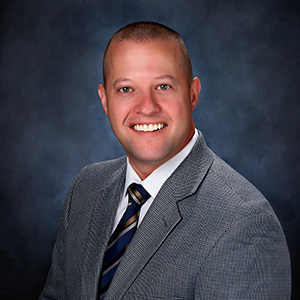 Eric McGuire in a suit and tie